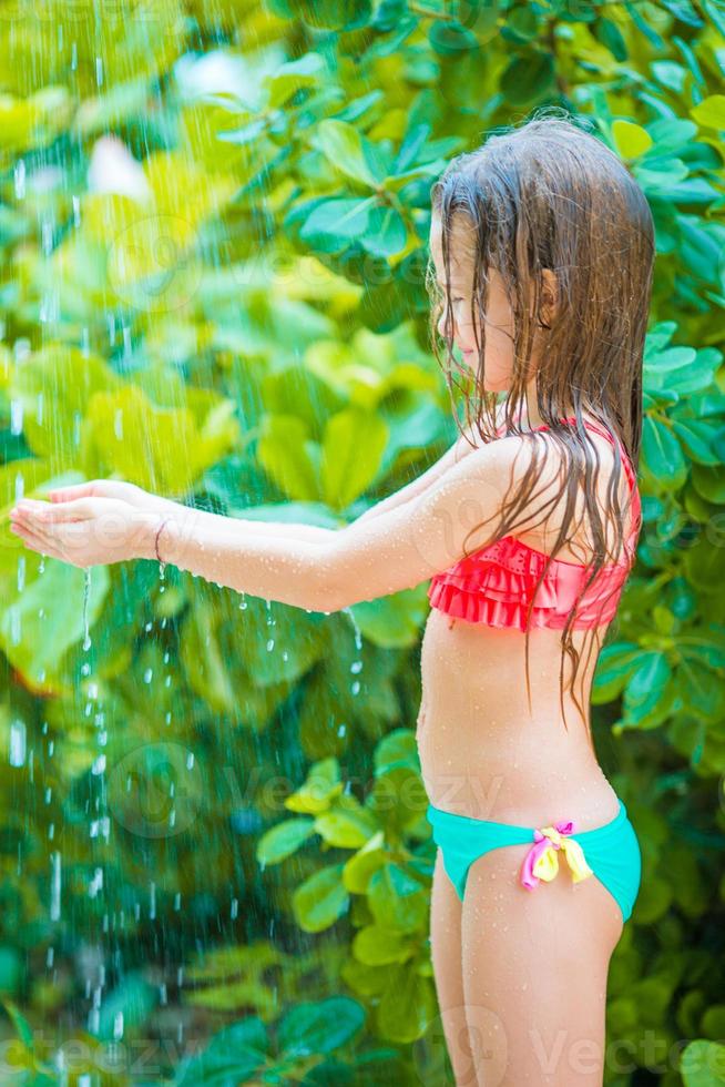 Little girl on outdoor shower after the beach 20092631 Stock Photo at
