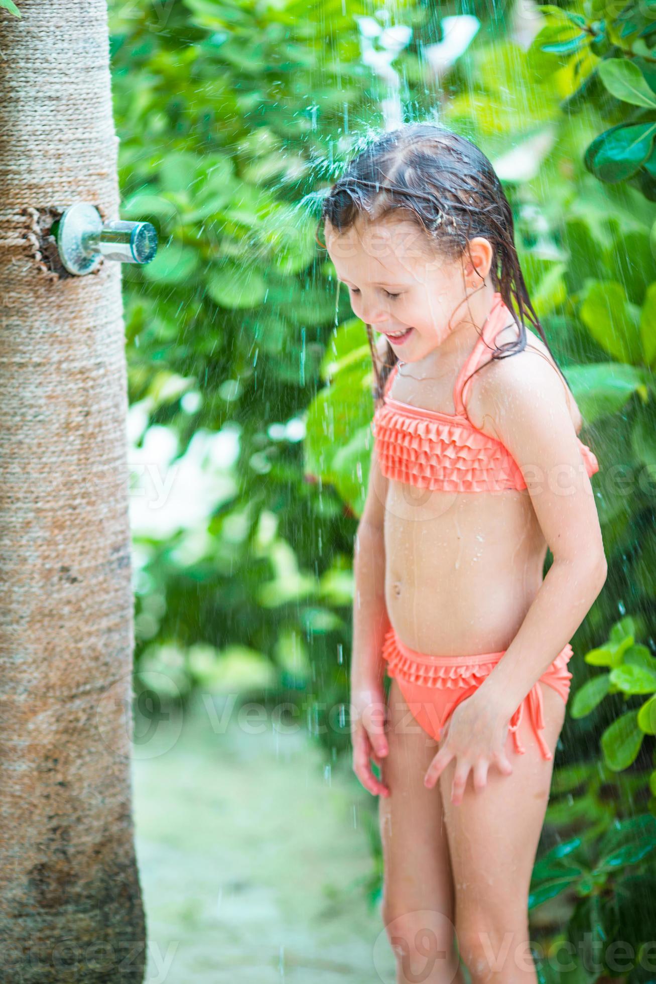Little girl on outdoor shower after the beach 20092654 Stock Photo at