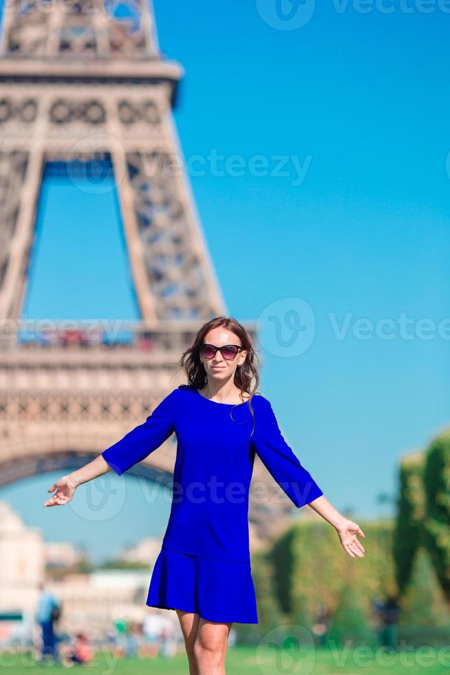 Young woman in front of the Eiffel Tower, Paris - France photo