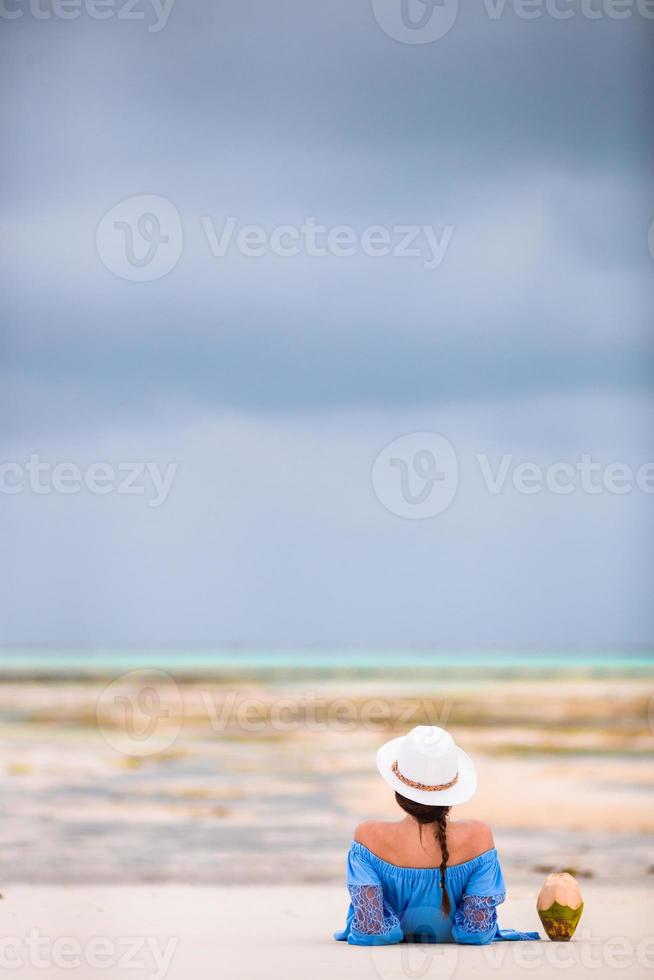 Woman in blue dress laying on the beach photo