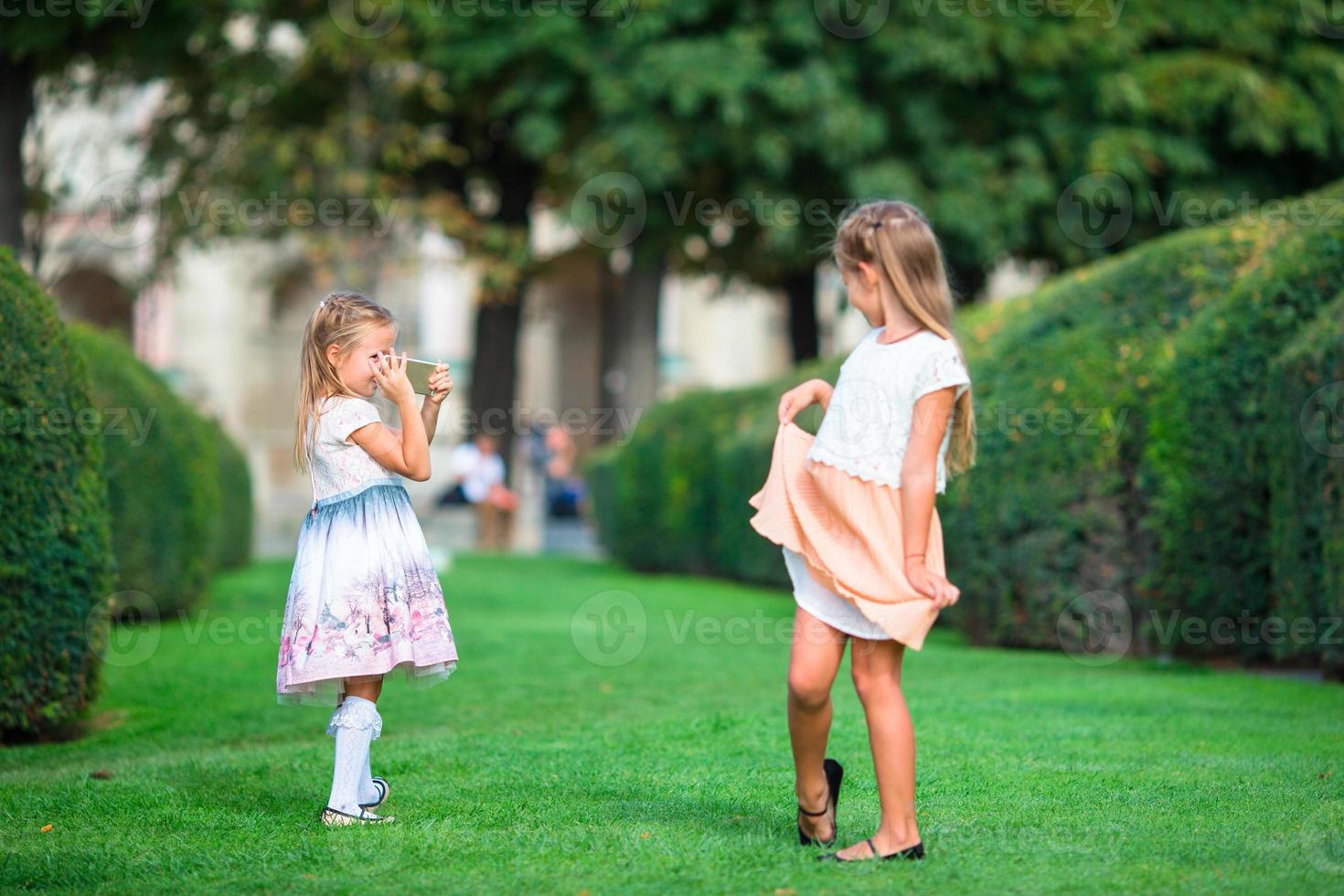 Little sisters on the grass photo
