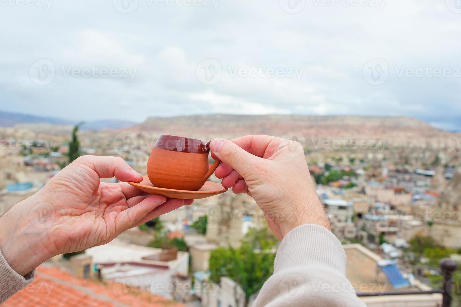 Hand holding a coffee mug in Cappadocia, Turkey photo