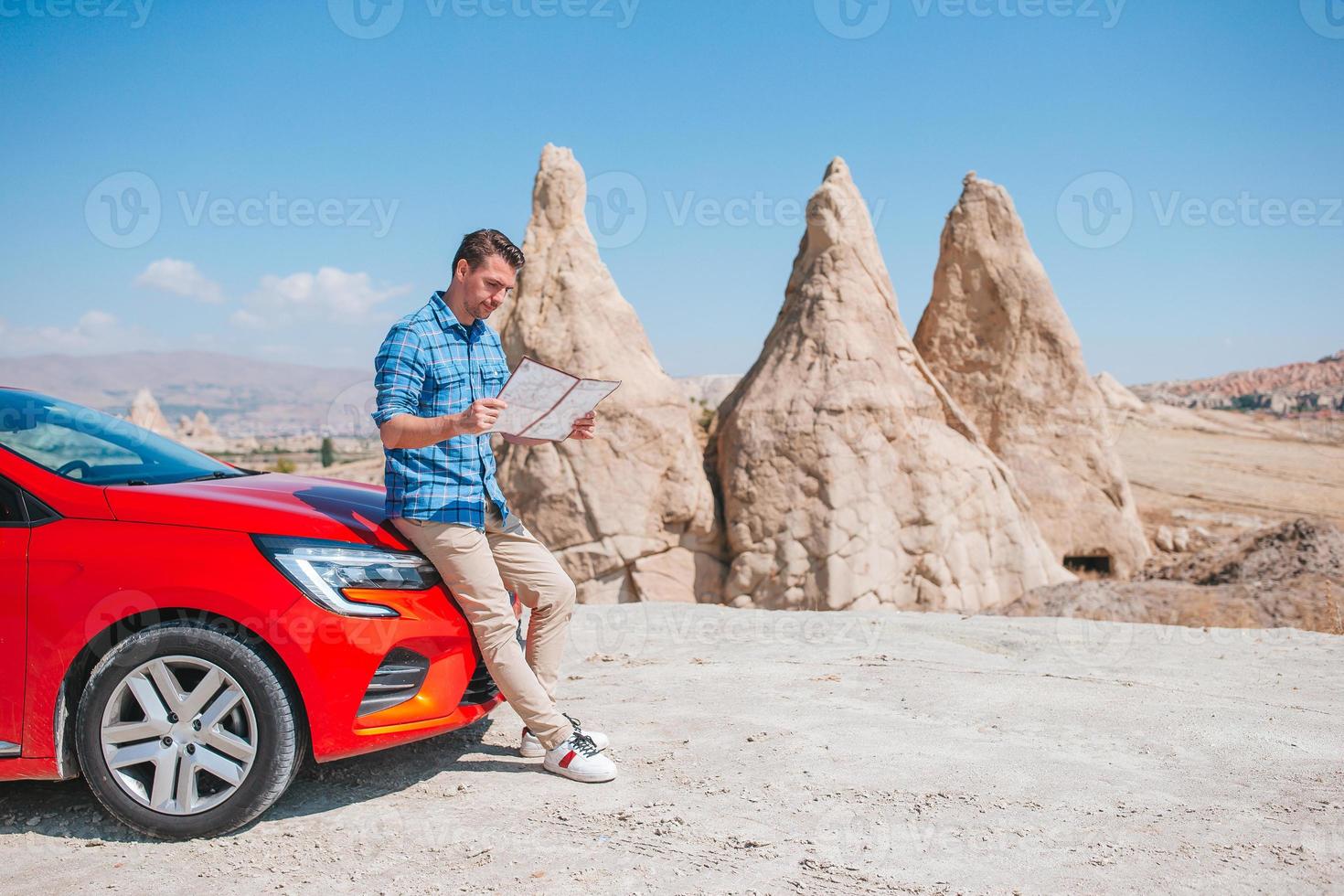 Man traveling with a red car photo