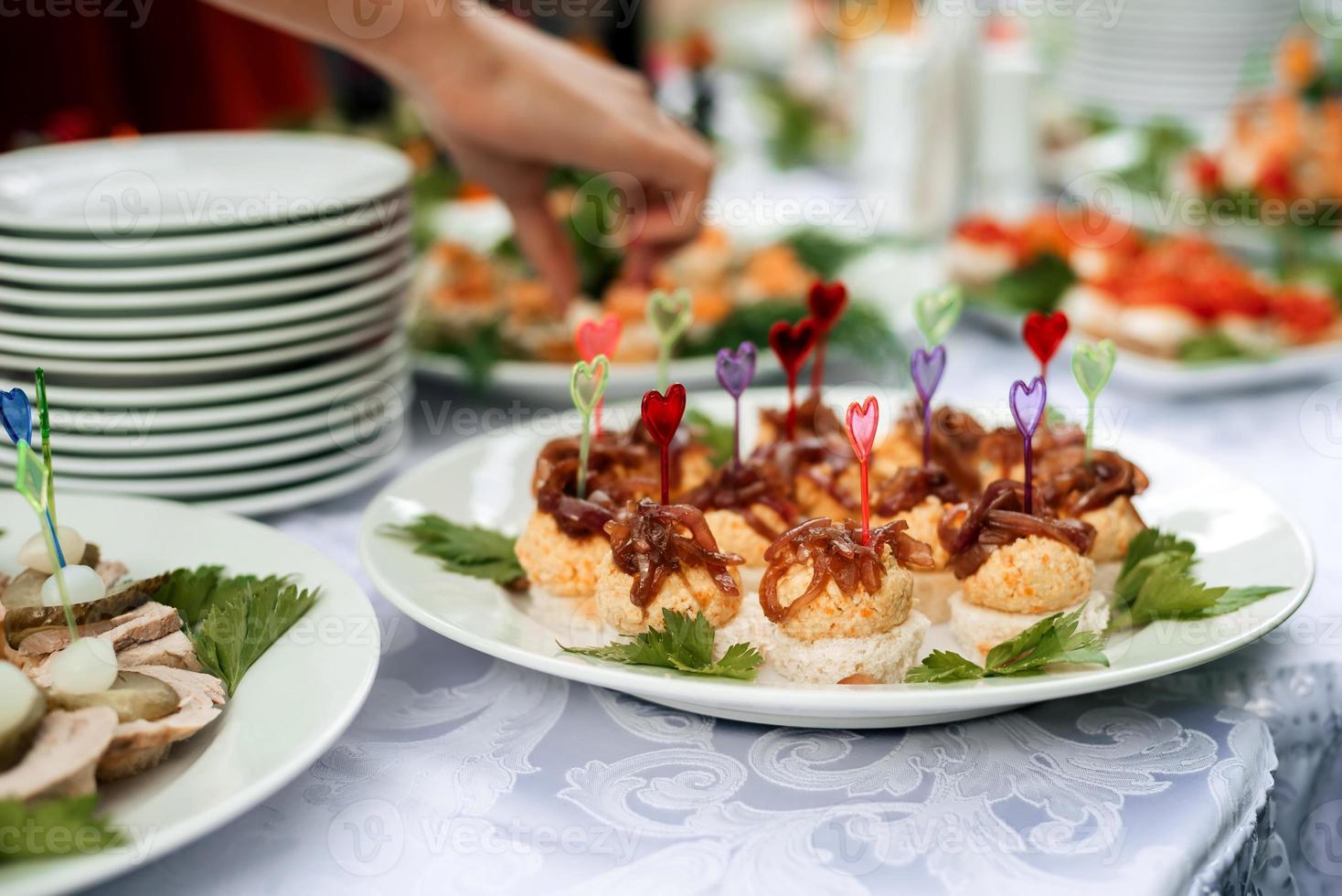 table set with light snacks, canapes and glasses photo