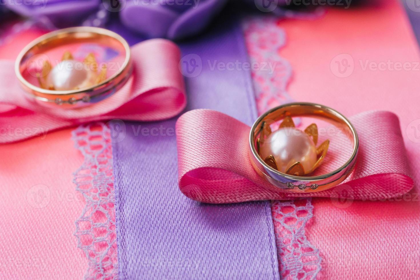 Wedding rings lying on a soft wedding pillow photo