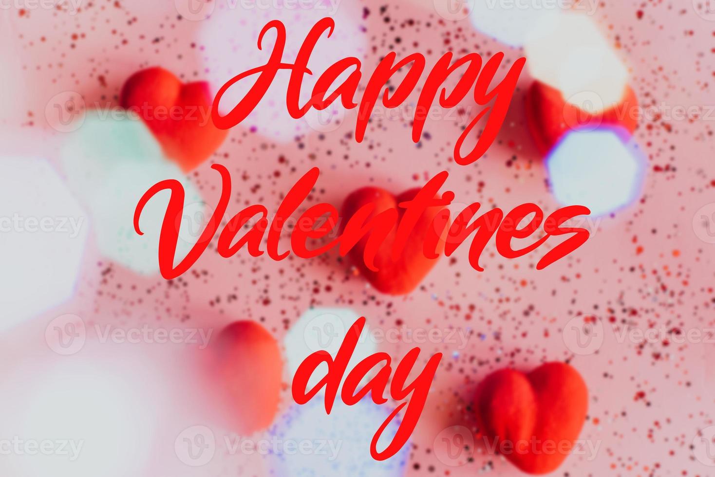 Happy valentine's day text on blurry Pink Background with Hearts. photo