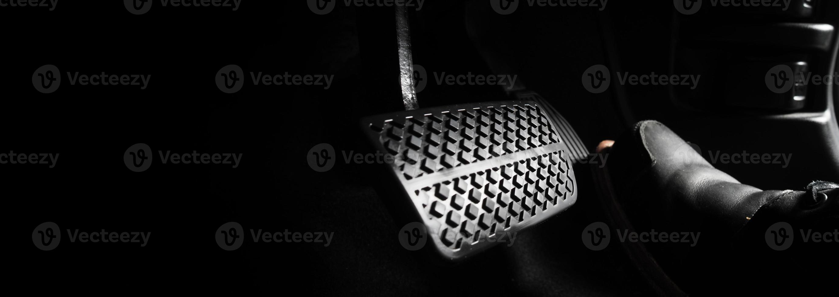 Close up foot press or push foot break and accelerate pedal of a car to drive ahead. photo