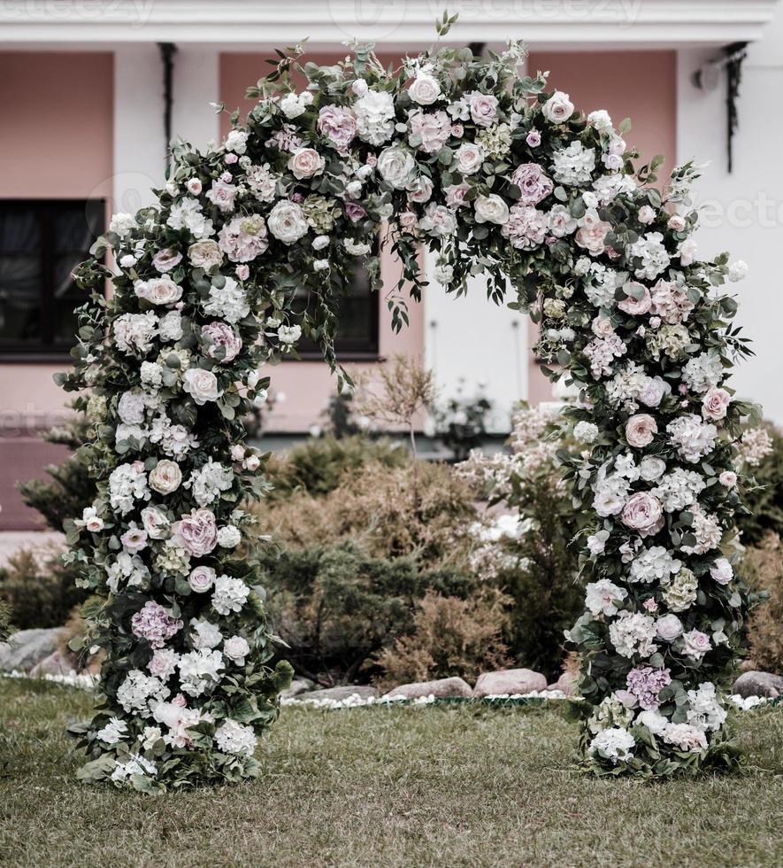 Beautiful wedding arch with flowers photo