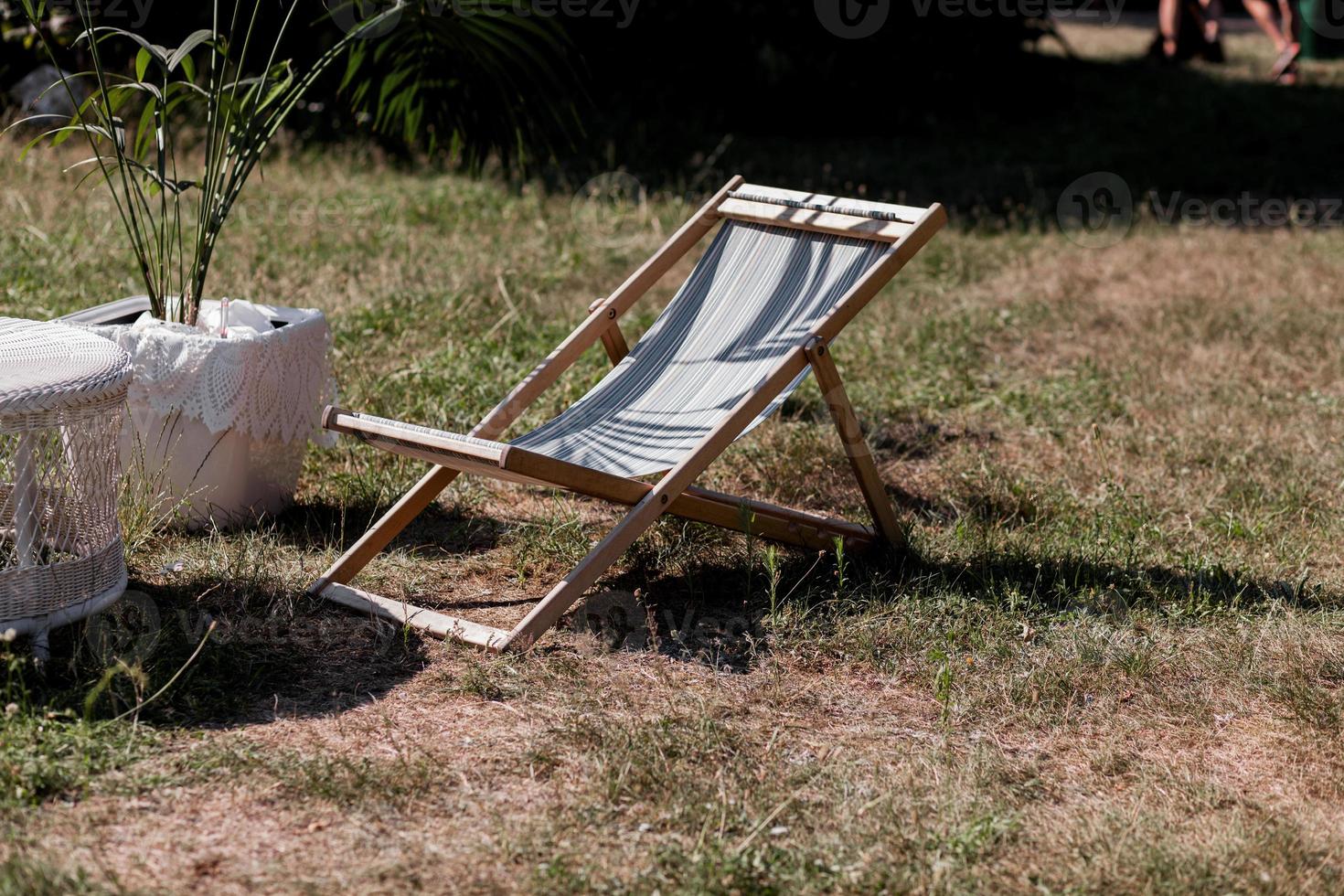 Wooden sunbed on garden photo