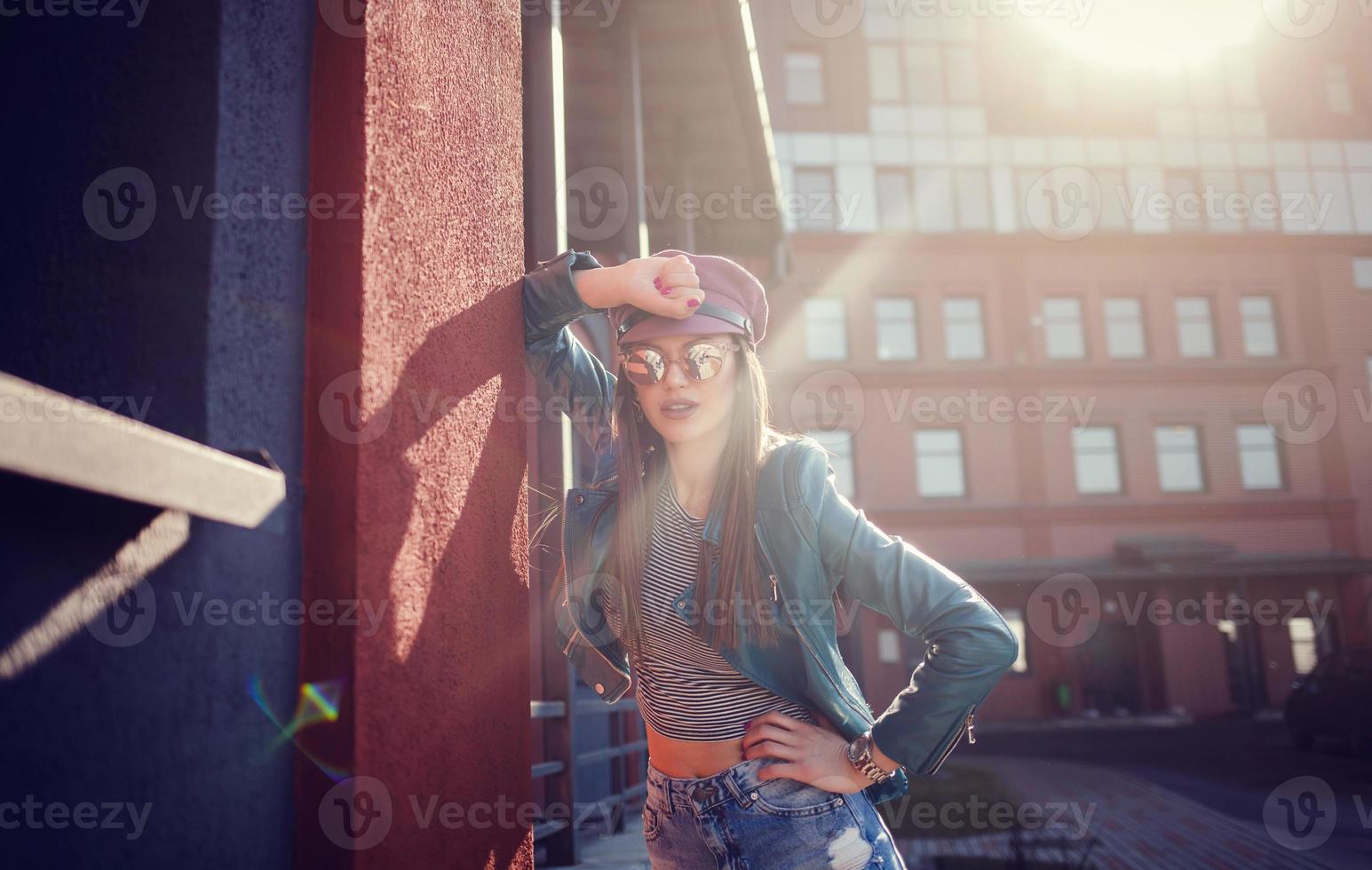 Cheerful young woman in sunglasses and hat photo