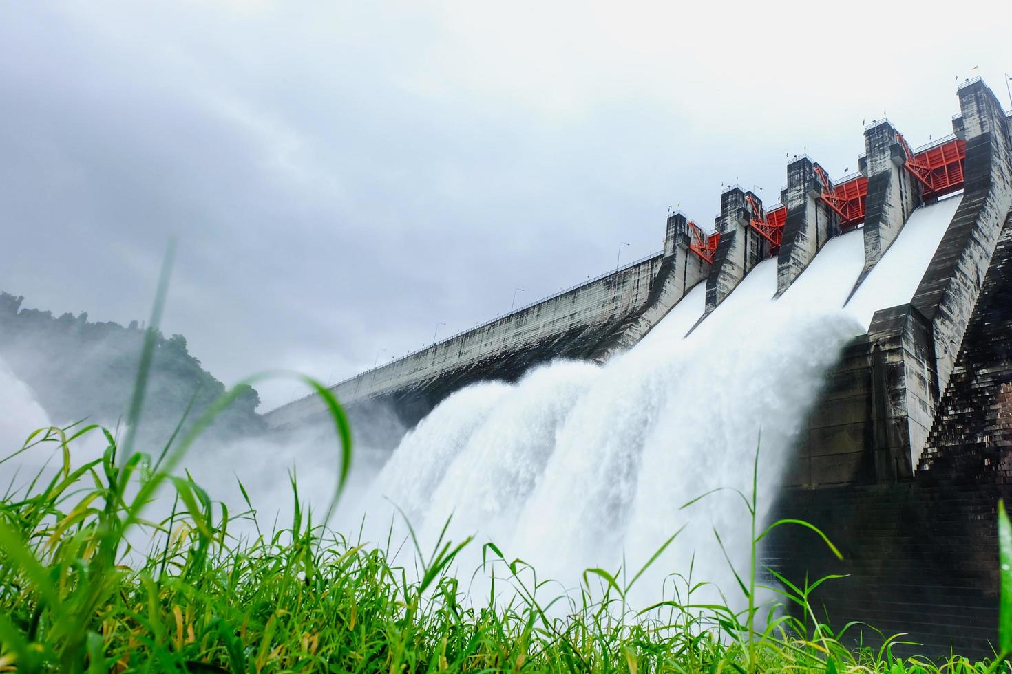 landscape of dam with water falling photo