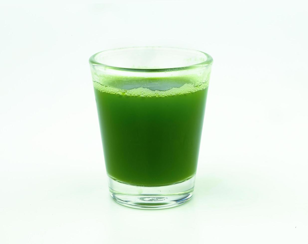 shot of wheat grass juice on white background photo