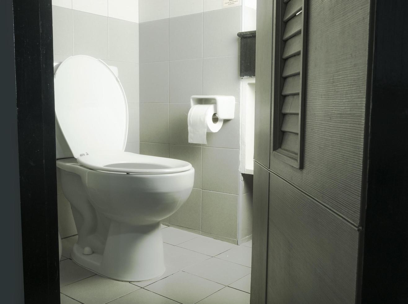 bathroom with ceramic toilet bowl and toilet paper photo