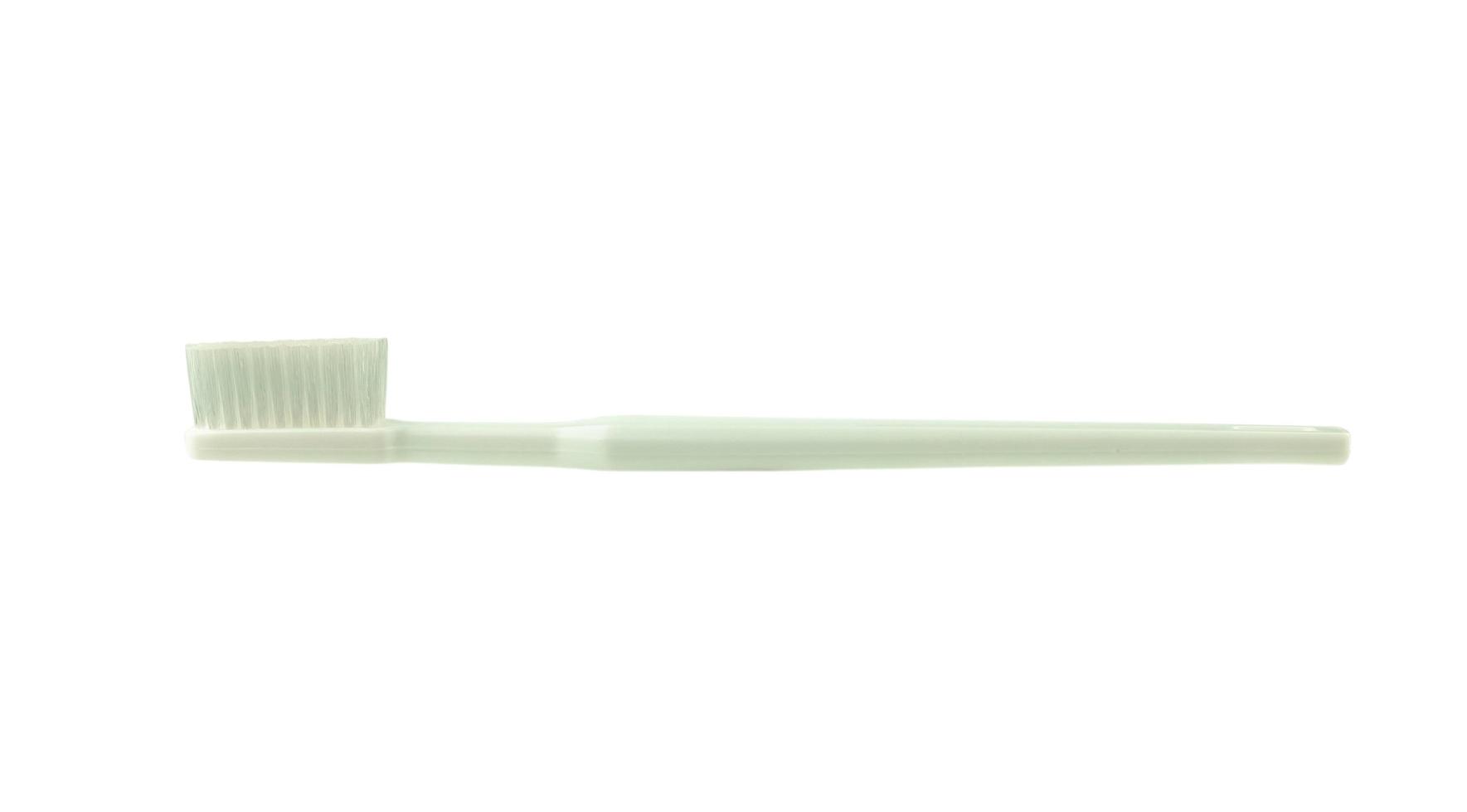 single white plastic toothbrush isolated photo