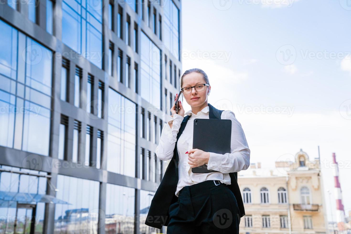 Successful businesswoman or manager, woman talking on mobile phone while photo