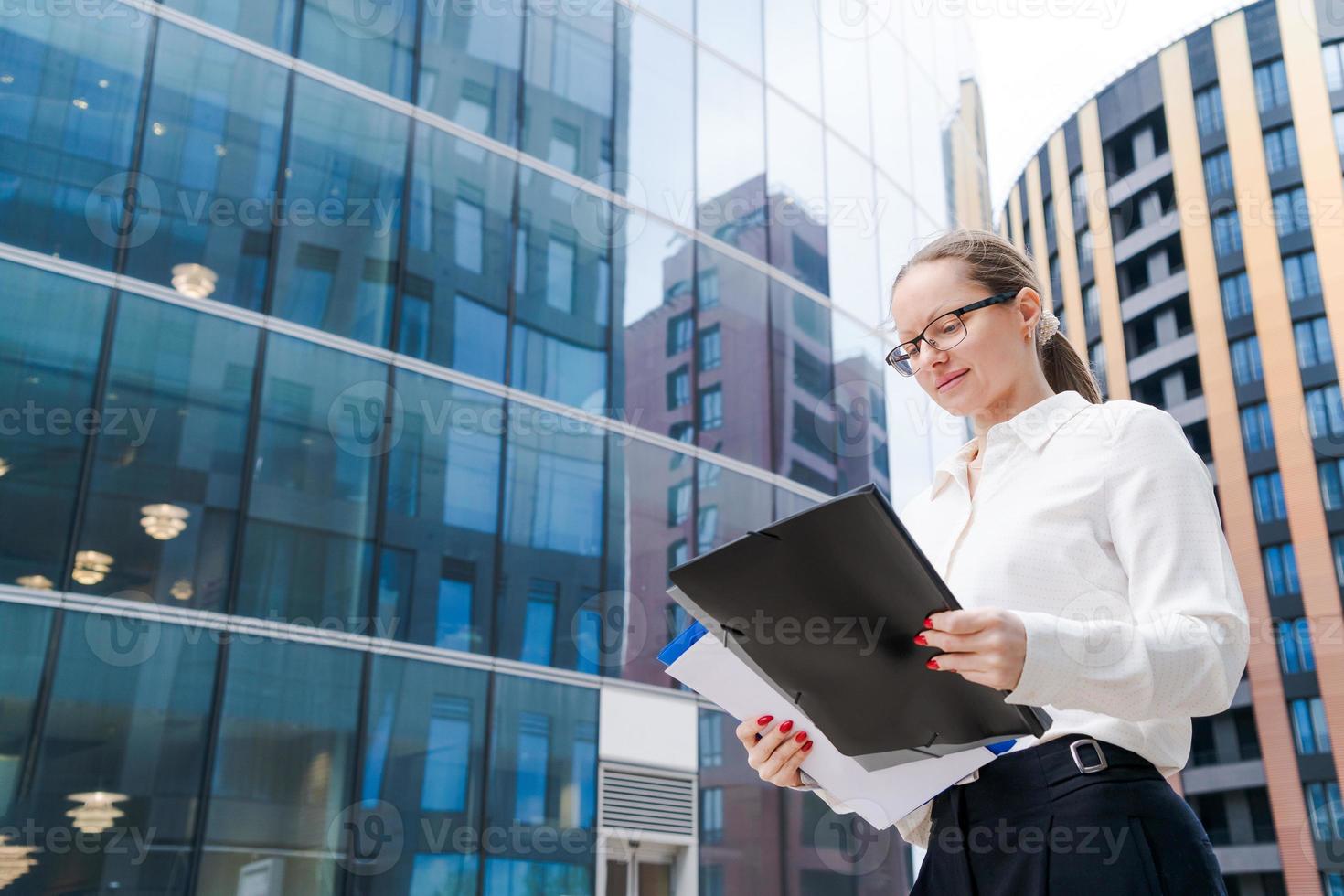 Business woman successful woman walking outdoors, corporate building, outdoor photo