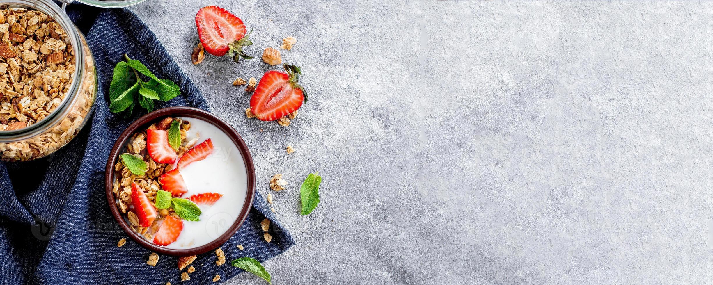 Food Background. Breakfast with yogurt, granola or muesli, strawberries. Banner image for website photo