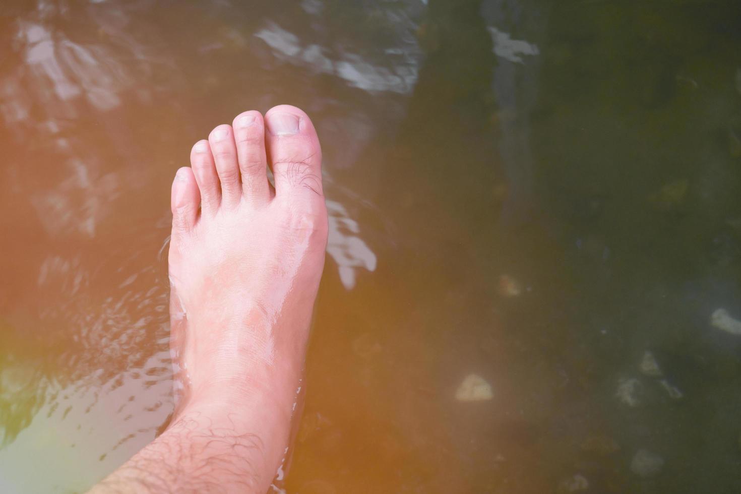 Soaking foot in the water at hot spring foot bath for therapy photo