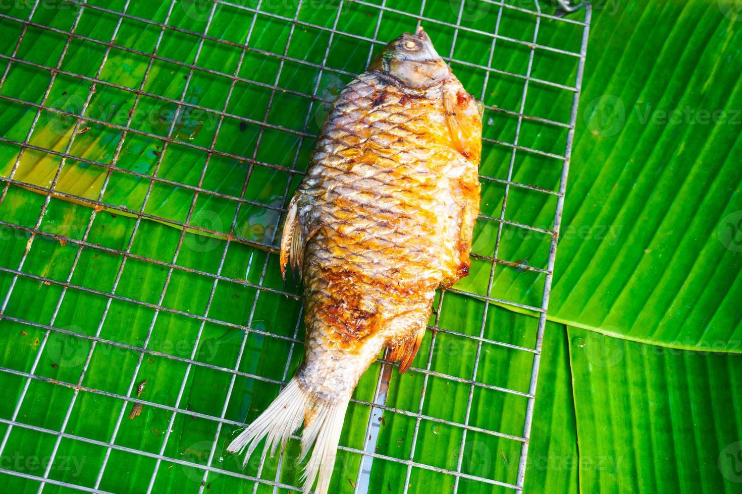 Fish burned, cooked and placed on green banana leaves,Top view photo