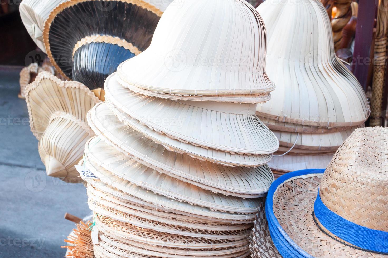 Handmade hats woven from bamboo hats arrangement on market hand craft shop photo