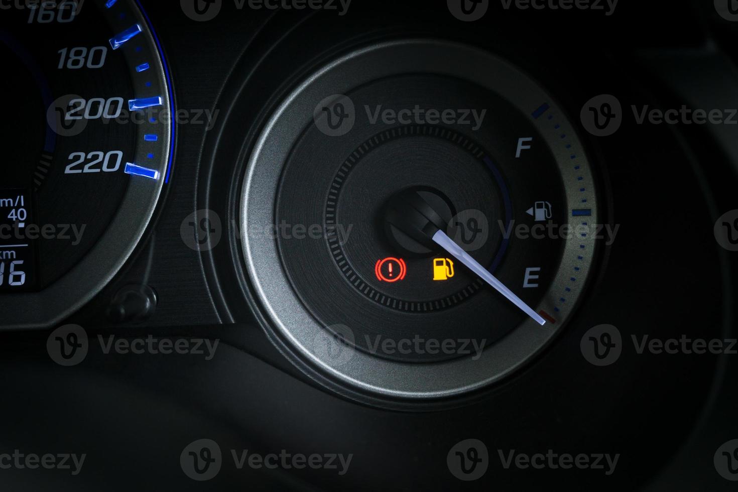 Detail with the fuel gauges showing and empty tank on dashboard of car photo