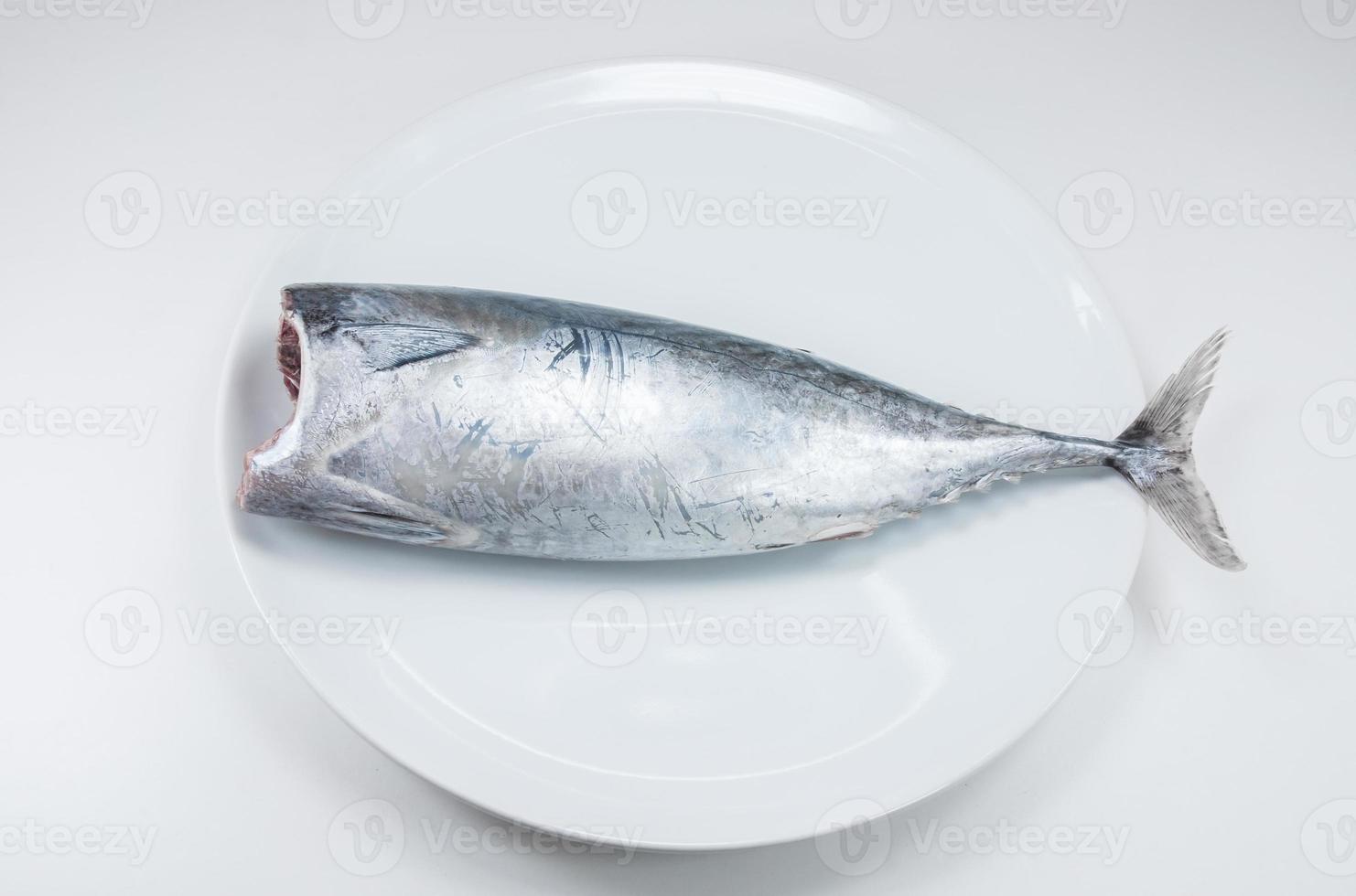 Tuna fish raw on white dish on white background photo