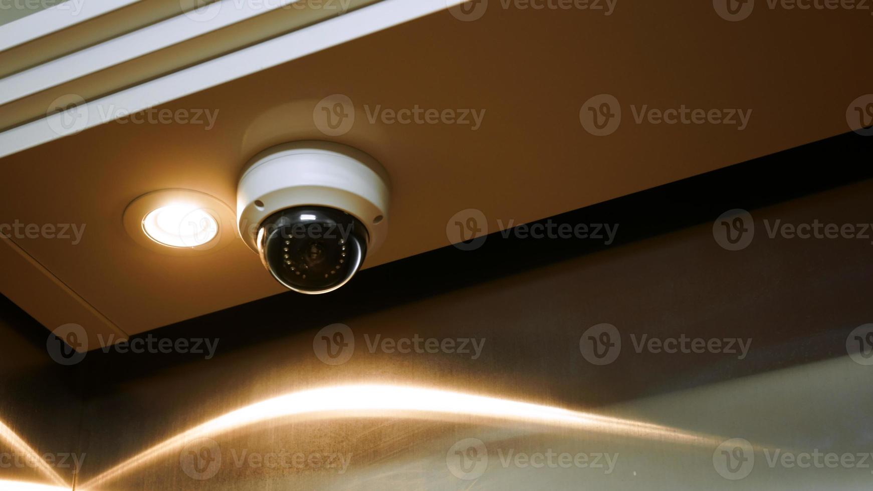 Security CCTV camera or surveillance system inside the elevator ,Closed-circuit television,Modern CCTV camera on a wall photo