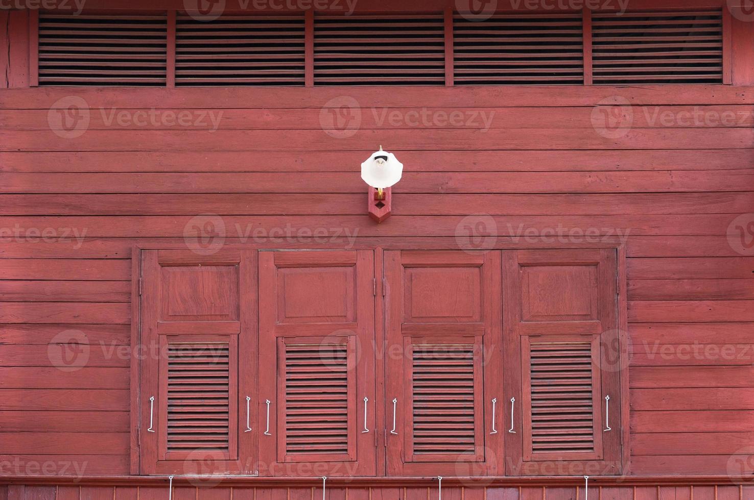 Vintage windows with  wooden shutters on the exterior and antique lamps photo