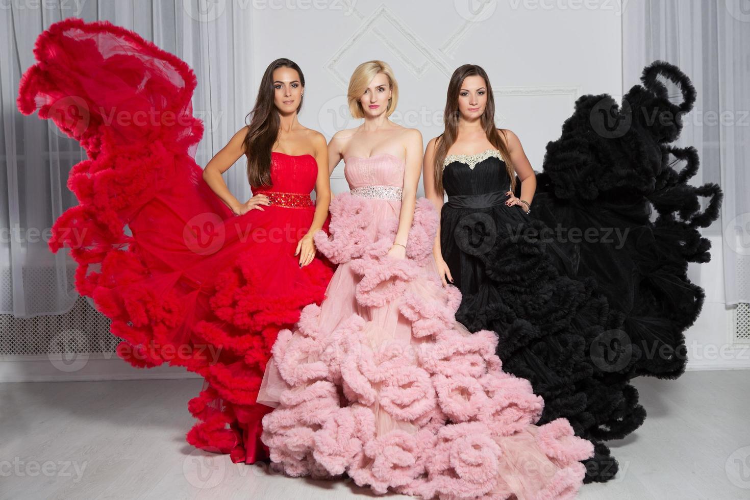 Three beautiful woman posing in the studio photo