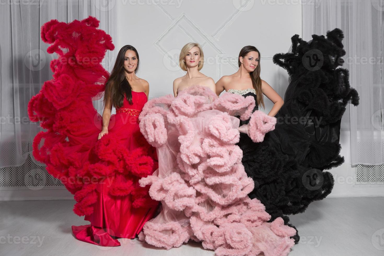 Three cute woman posing in the studio photo