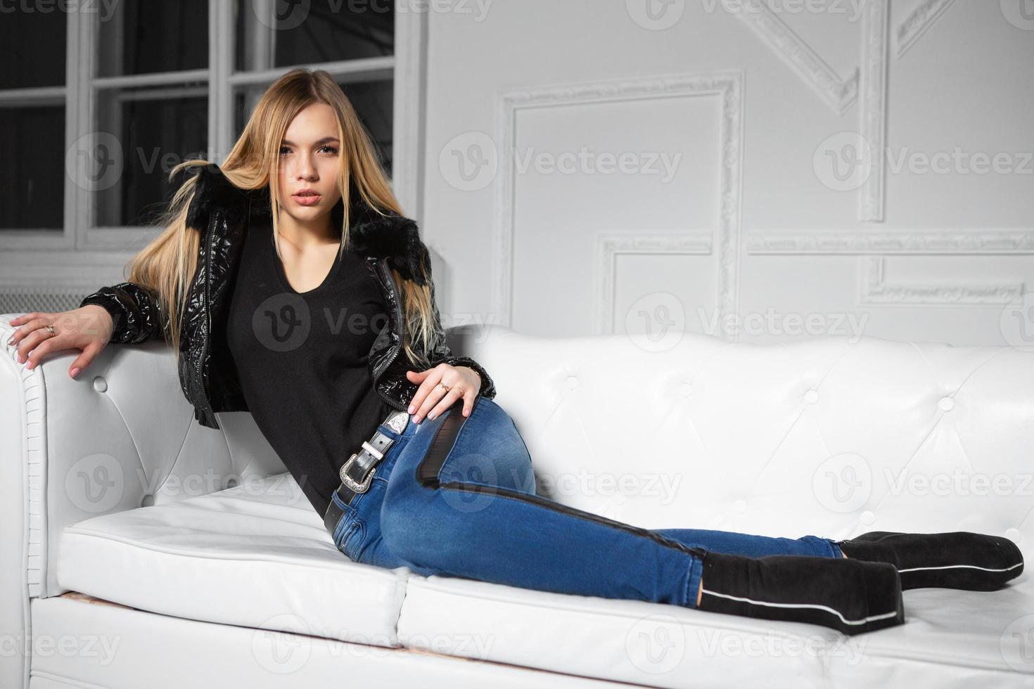 Pretty woman posing lying on a sofa photo