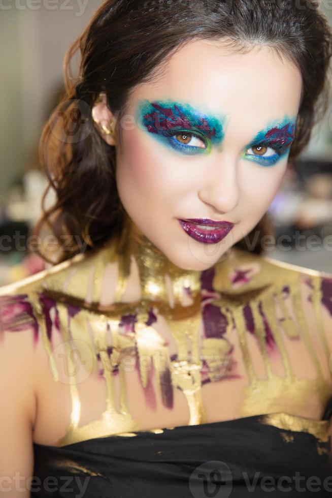 Young alluring brunette with creative make up photo