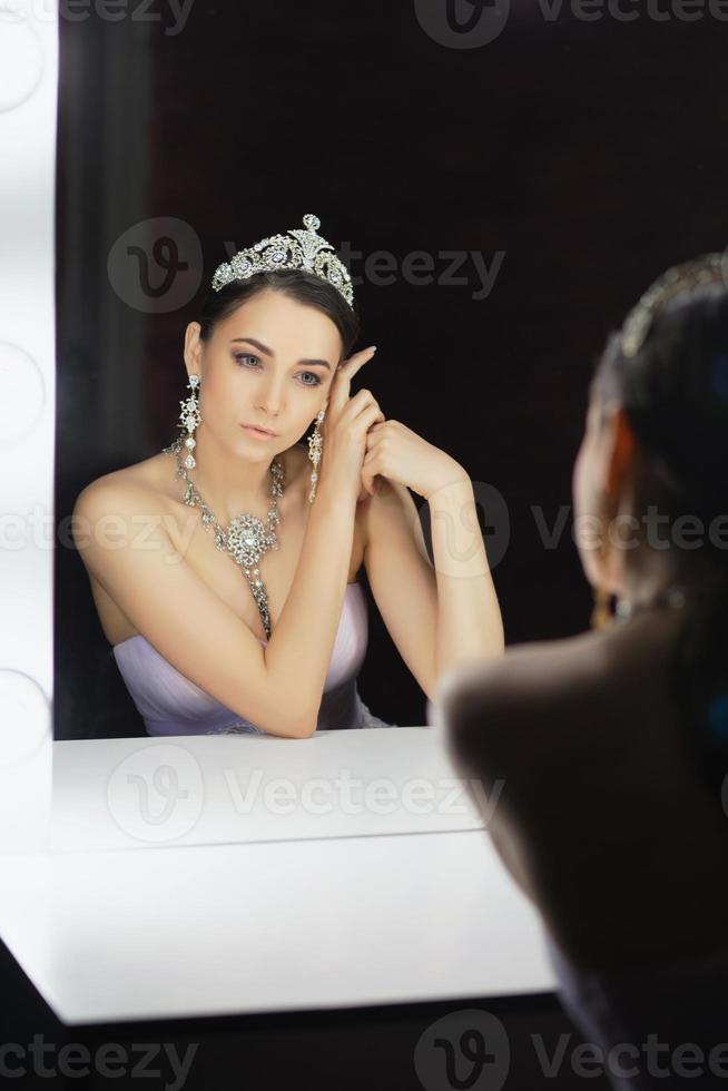 Reflection of a cute woman posing in a studio photo