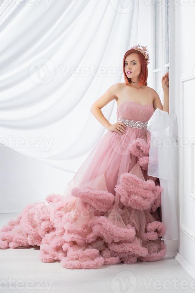 Nice young redhead woman posing in a studio photo