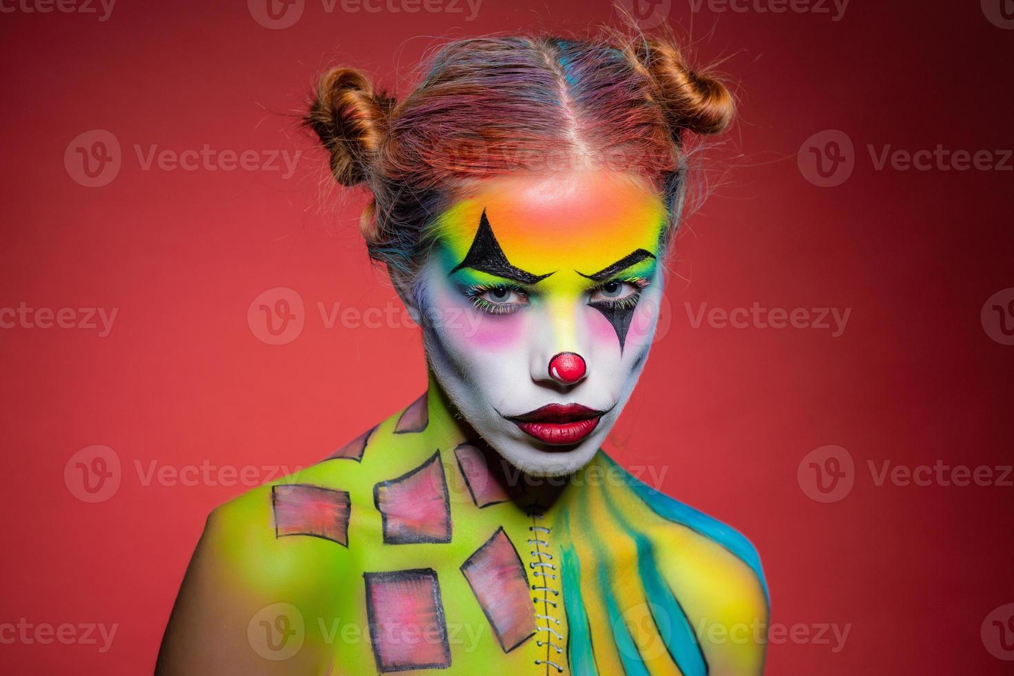 Nice young lady with a face painting clown photo