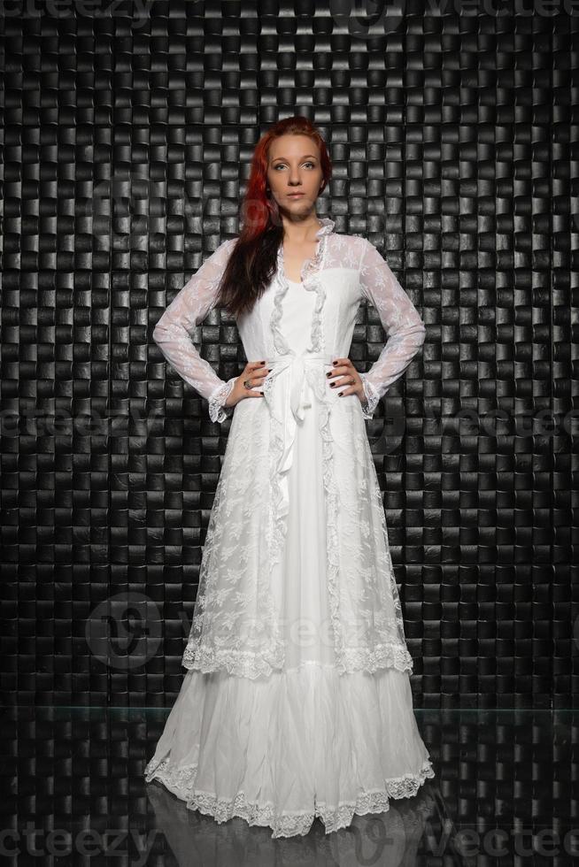 Pensive redhead lady posing in studio photo