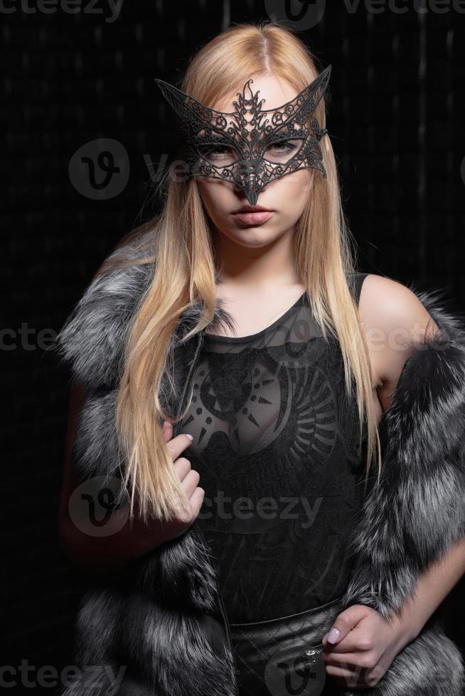 Young pretty blonde in a mask photo