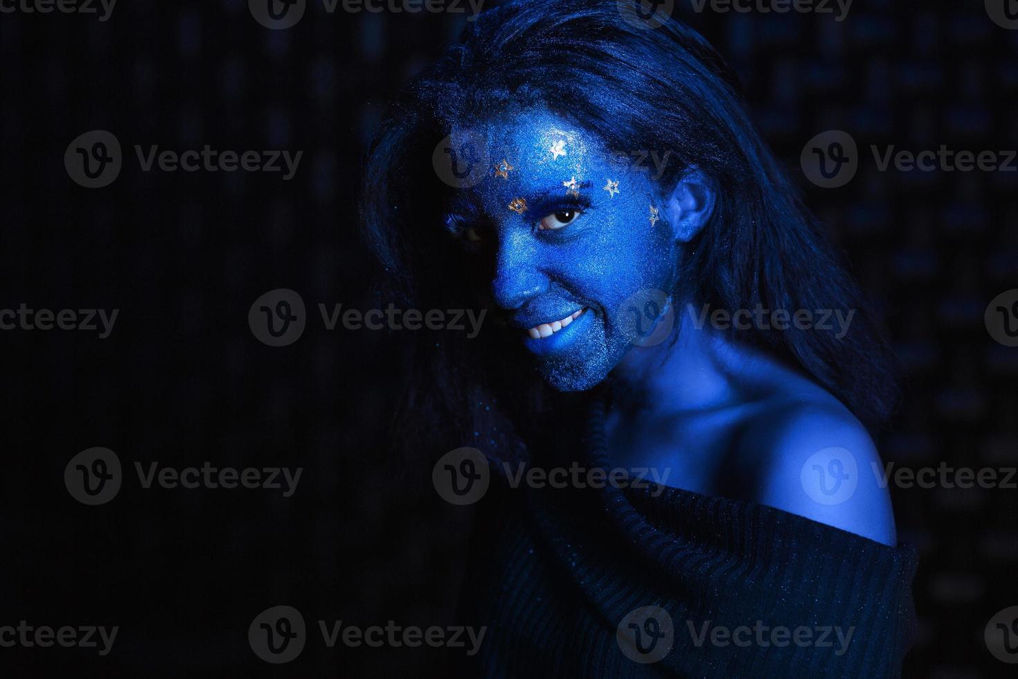 Young beautiful girl with blue aqua makeup photo