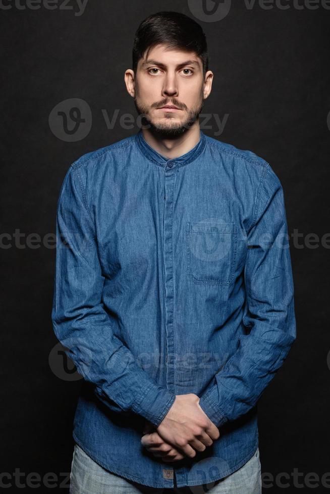 Alluring man posing in studio photo