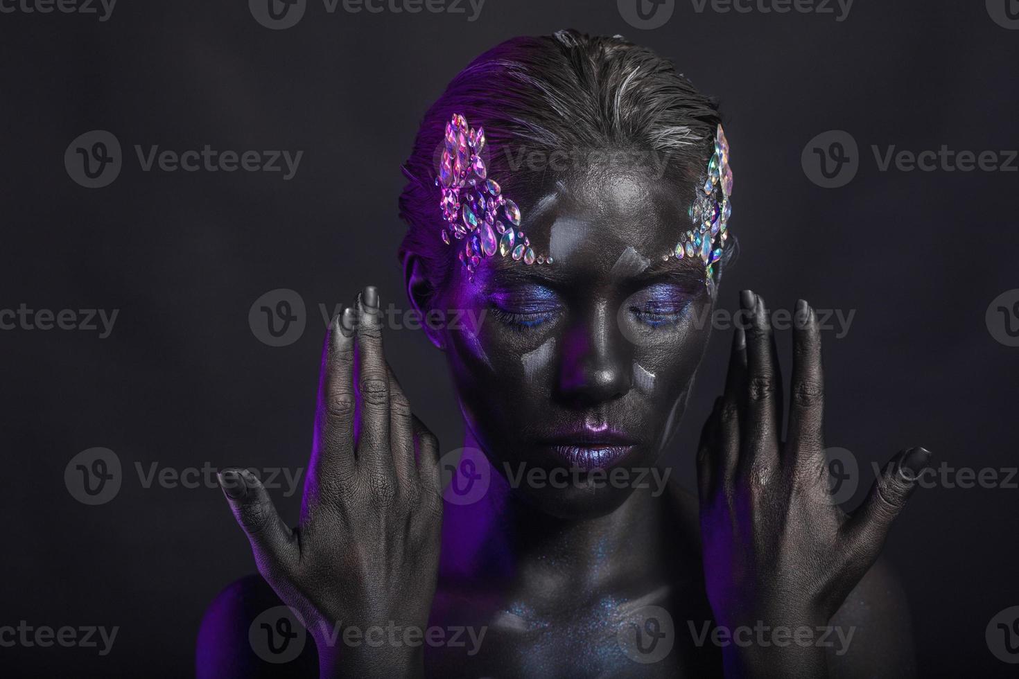 Beautiful brunette with creative makeup on face photo