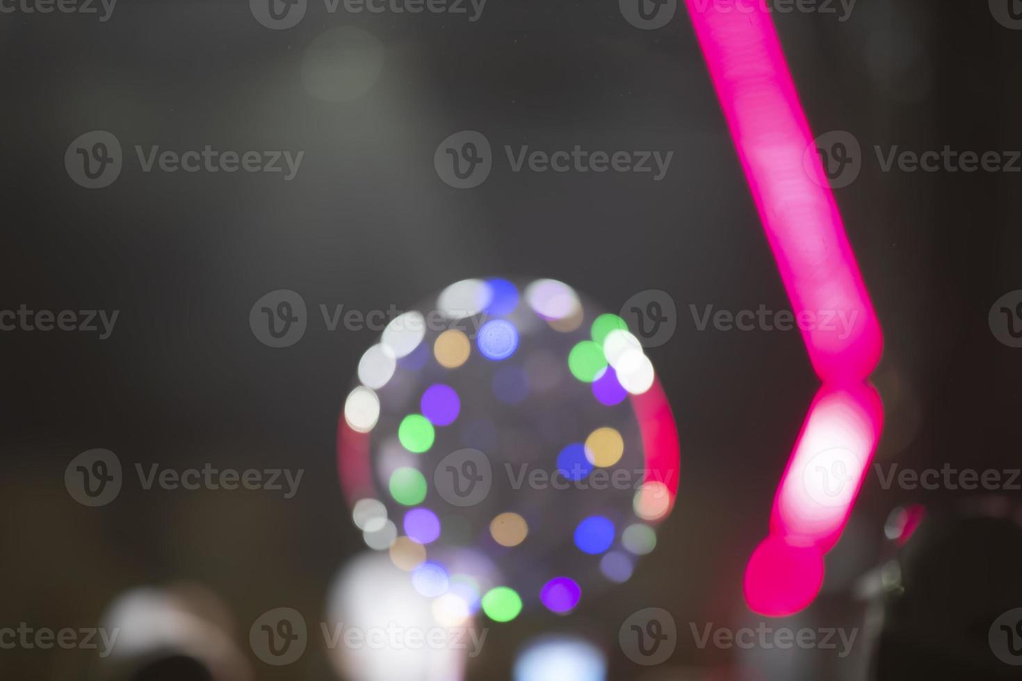 Bright pink stripes of optical bokeh on a dark background. photo