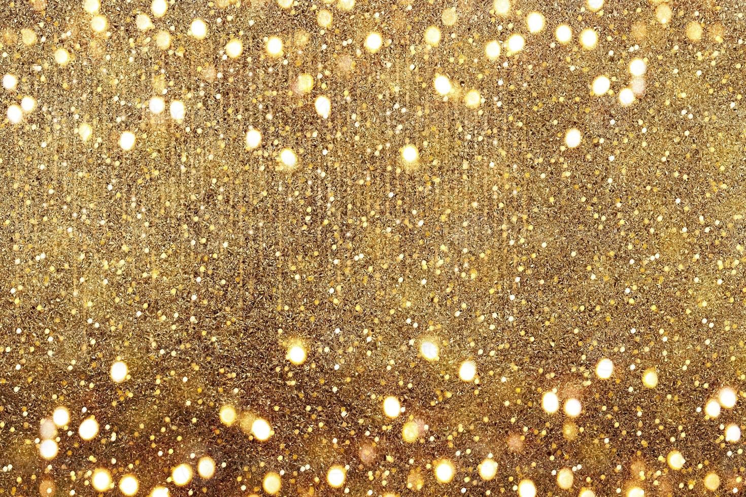 Gold bokeh. The effect of and blurring shiny balls. Defocused holiday lights. Glitter. Abstraction. photo