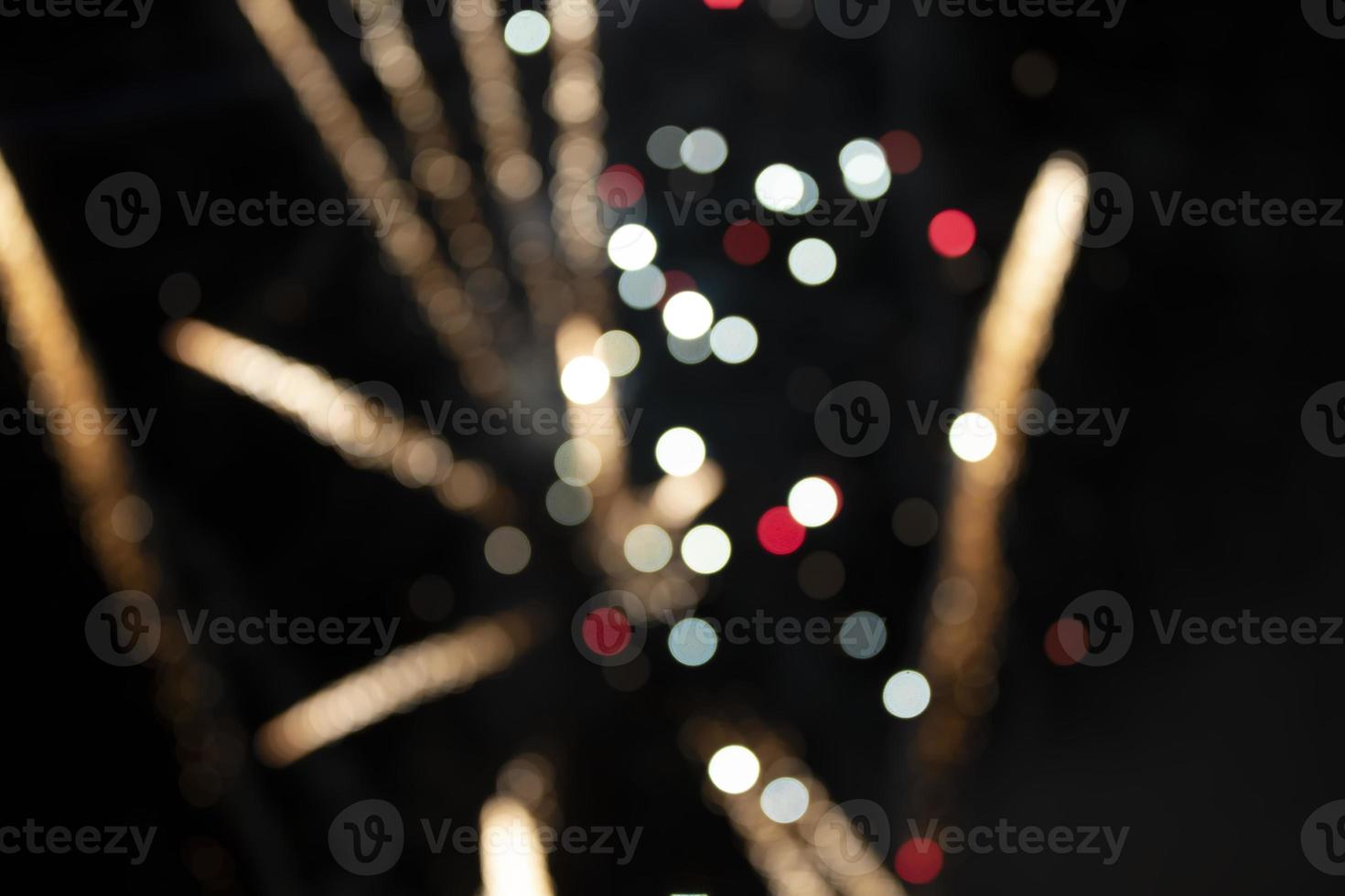 On a black background bokeh from explosions of colorful fireworks. photo