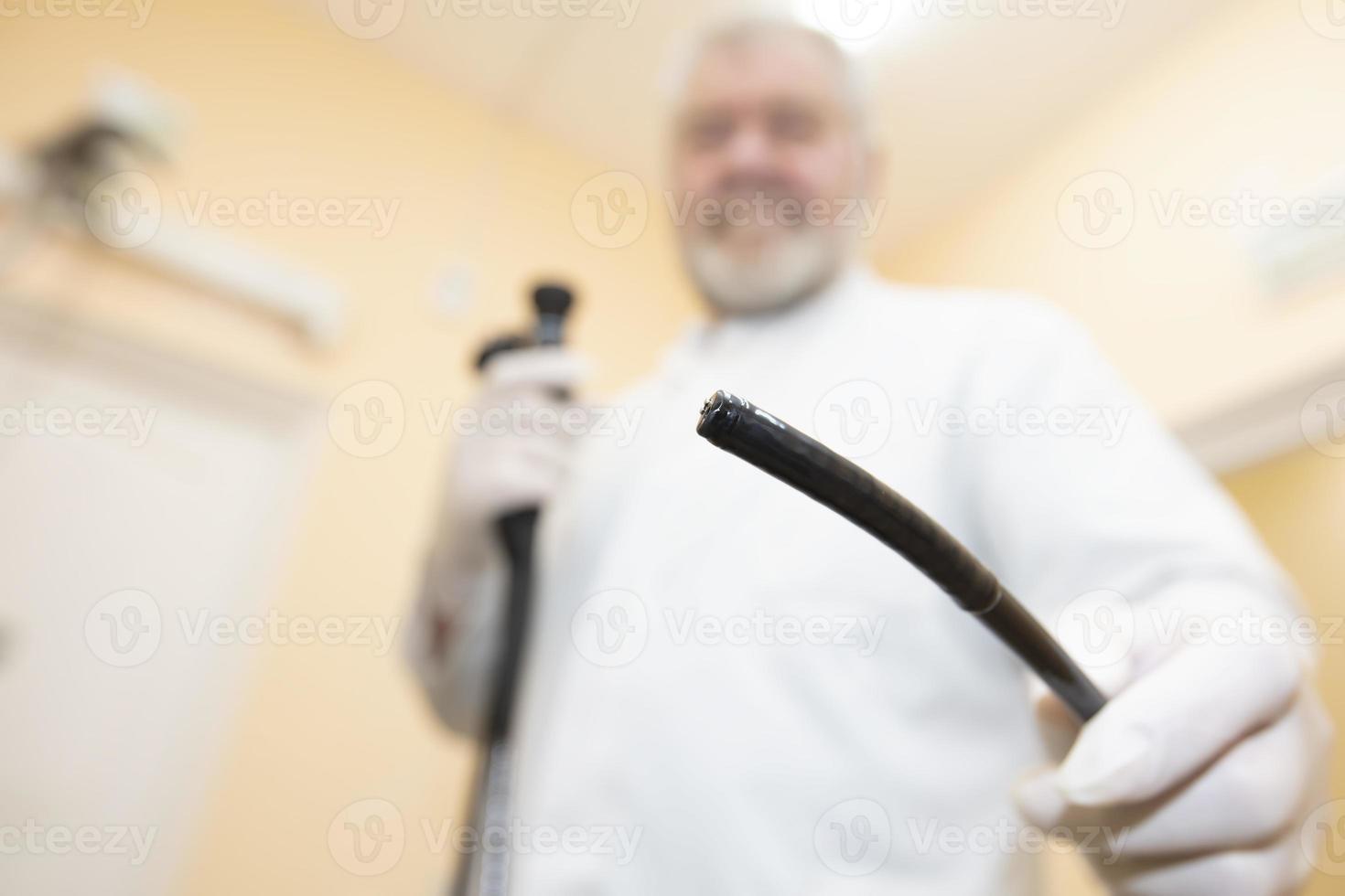 Probe for the study of the stomach close-up on the background of a blurred doctor. photo