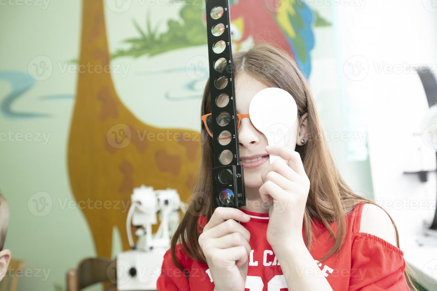 A little girl with visual impairment is being treated. photo