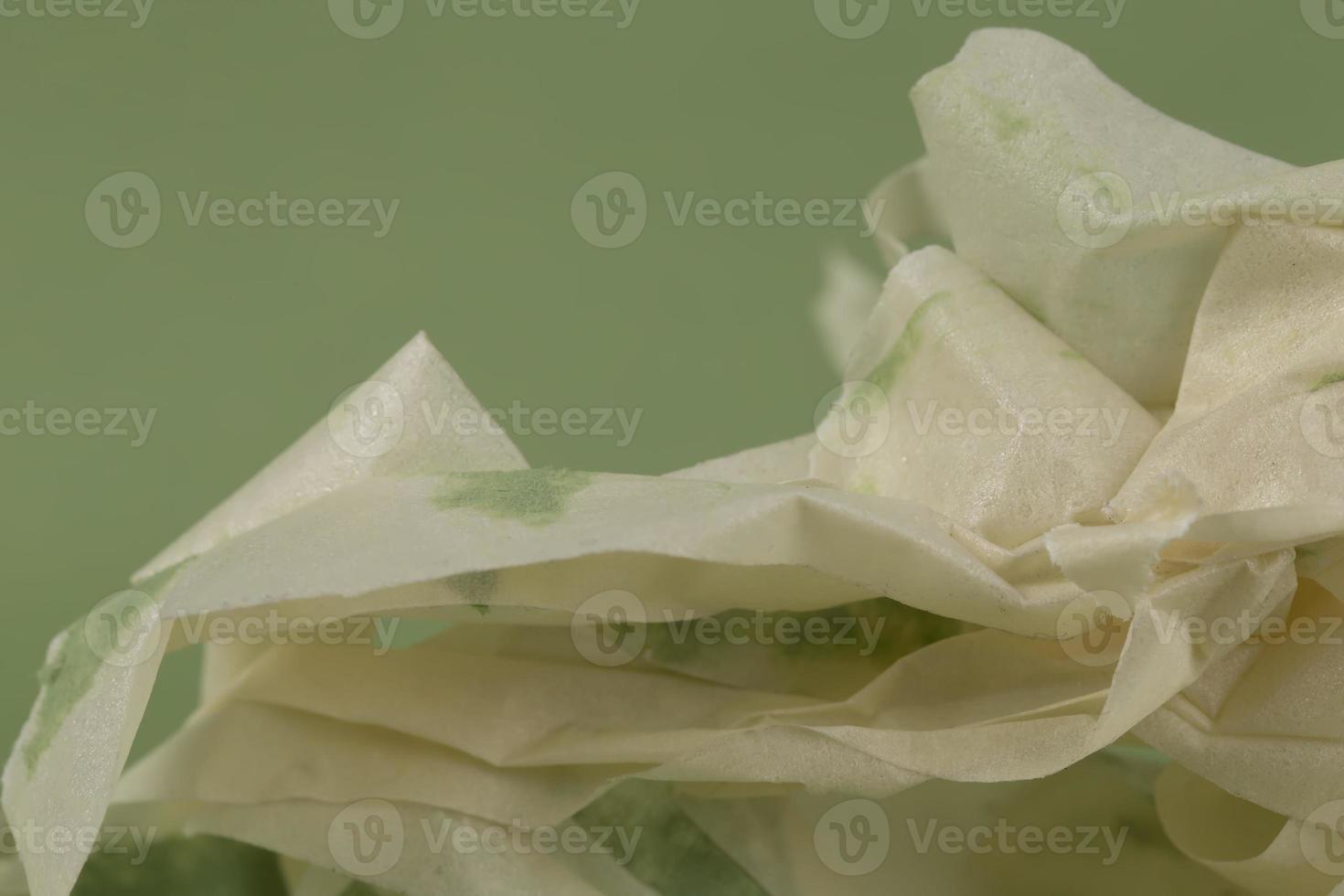 Background from crumpled paper with a green tint. photo