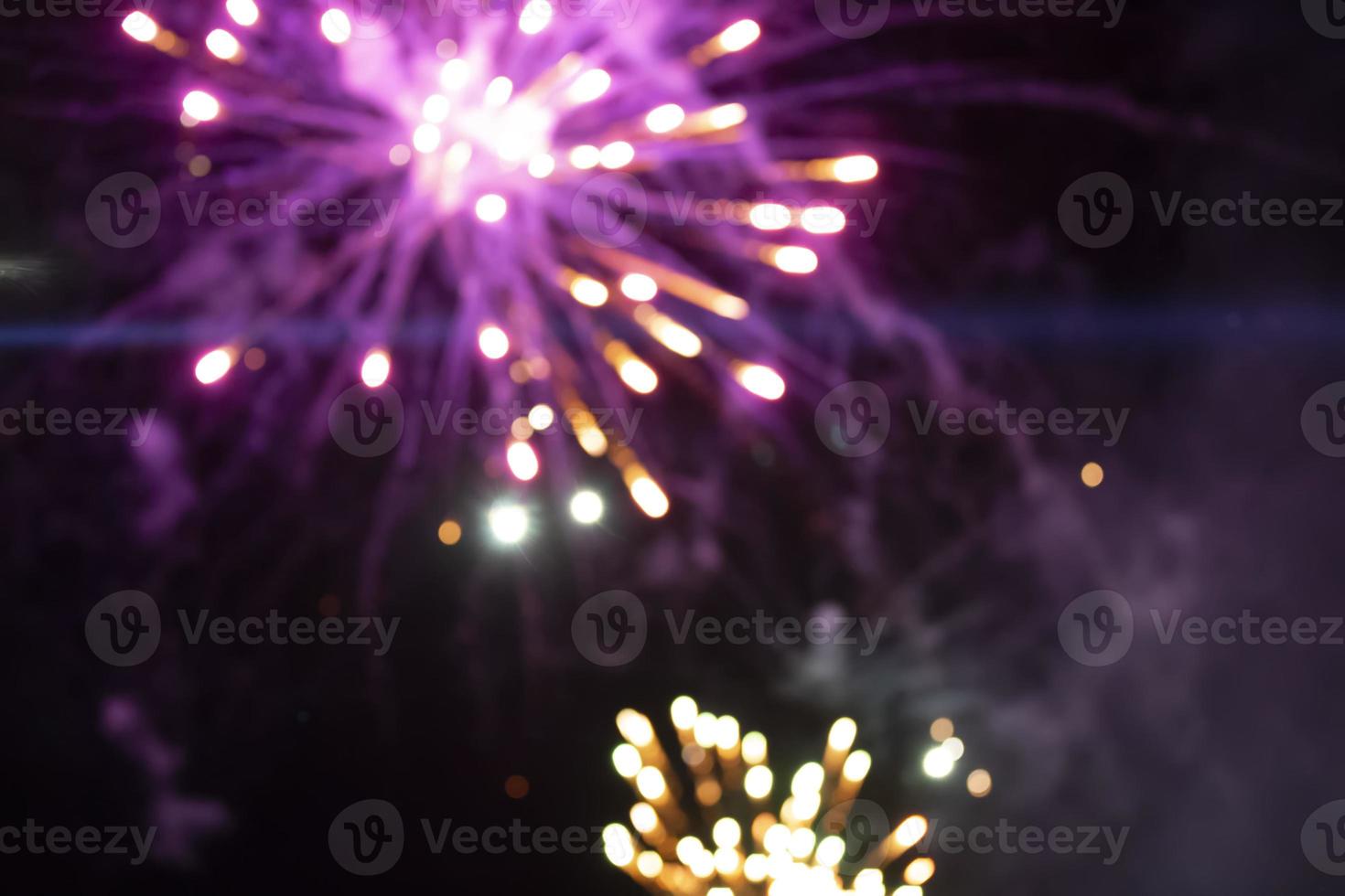 On a black background bokeh from explosions of colorful fireworks. photo