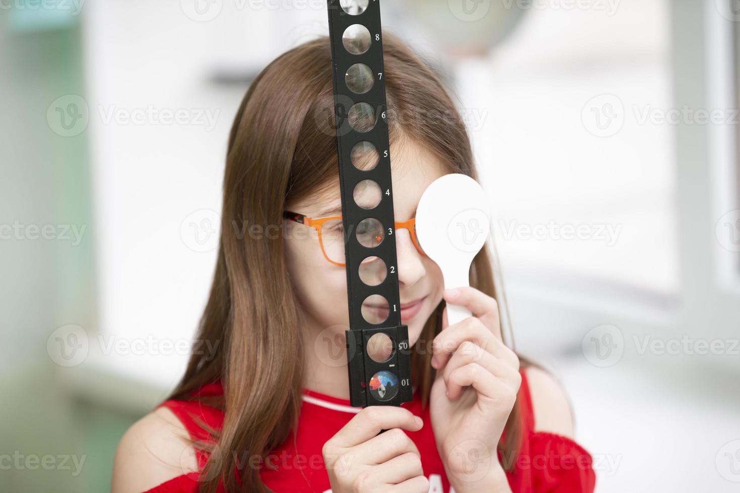 A little girl with visual impairment is being treated. photo