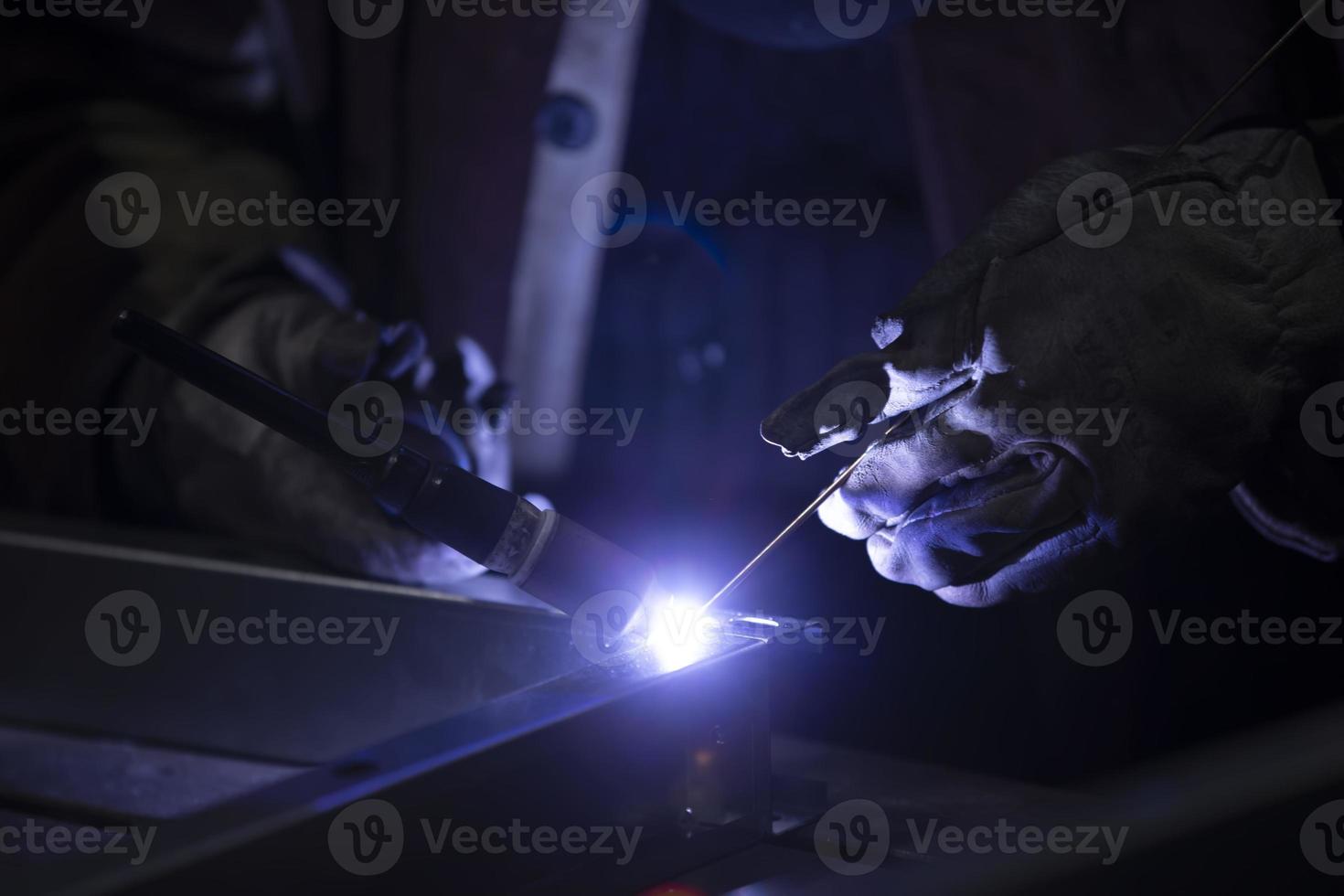 Weld a metal seam with argon arc welding. Welding works on metal. photo