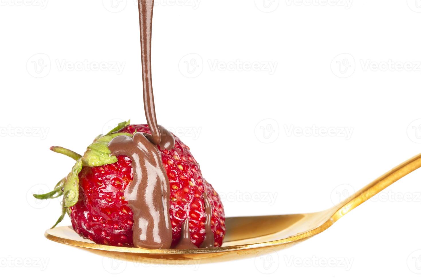 Strawberries on golden spoon with chocolate dipping isolated on white. Chocolate dripping from strawberries. Beautiful red berry. Sweet dessert. photo